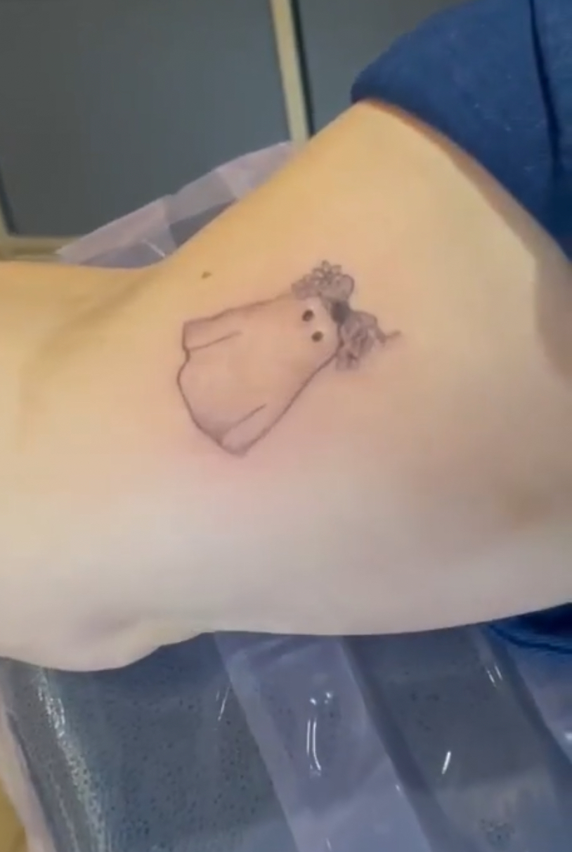 Fresh fine line tattoo of a little ghost figure