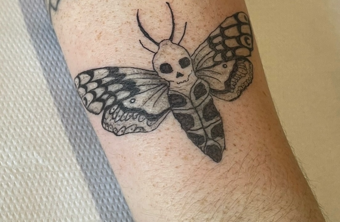 Fine line death's-head moth tattoo